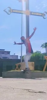 Skater performing in front of cross on sunny day.