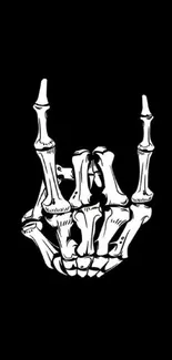 Skeleton hand rock sign on black background wallpaper.