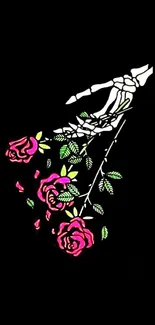 Skeleton hand holding pink roses on black background.