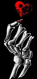 Skeleton hand with red heart on black background.