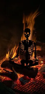 Skeleton in mediation pose by a glowing bonfire at night.