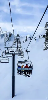 Ski lift ascending snowy mountain landscape with clear blue sky.