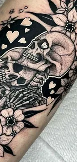 Black and white skull and floral tattoo art on arm.