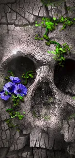 Cracked skull with vivid purple flowers and green ivy on a textured gray background.