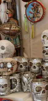 A display of skull-themed mugs and decorative items at a crafts market.