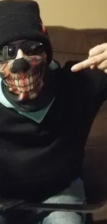 Person in skull mask with urban style vibe, seated casually.