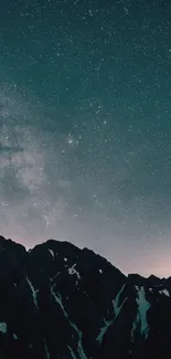 Starry night sky above dark mountain silhouettes.