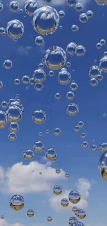 Floating bubbles against a bright blue sky with scattered clouds.