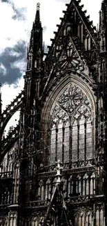 Gothic cathedral with intricate arch design and dramatic sky.