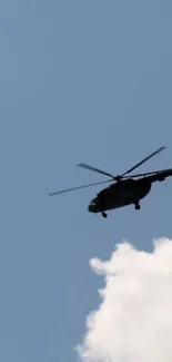 Helicopter flying in blue sky with clouds.