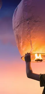 Sky lantern glowing at dusk with a serene background.