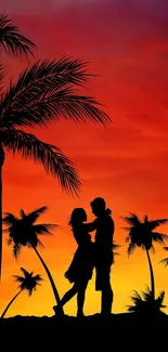 Silhouette of couple in love at sunset on tropical beach with palm trees.