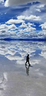 Person walking on a reflective surface with clouds in the sky.