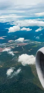 Aerial view of landscape from an airplane window, featuring clouds and sky.