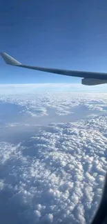 Airplane wing view with clouds below.