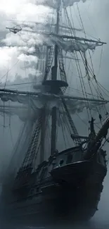 Majestic sailing ship cloaked in fog.