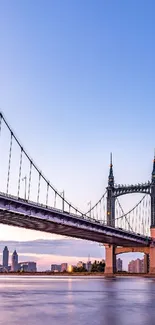 Mobile wallpaper of a bridge with a sunset skyline backdrop.