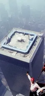 High-angle view of a skyscraper from a construction crane above the city skyline.