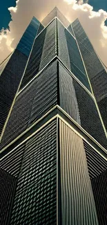 Symmetrical skyscraper with reflective facade against cloudy sky.