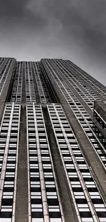 Skyscraper under dark stormy clouds with a dramatic urban view.