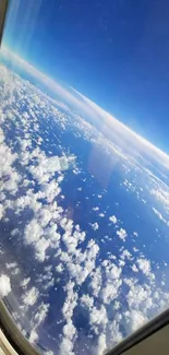 A stunning view of clouds and blue sky from an airplane window.