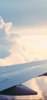 Airplane wing over clouds with a pastel sky background.