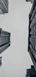 Urban skyline with tall buildings reaching up against a gray sky.