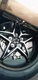 Sleek motorbike wheel with star-shaped spokes.