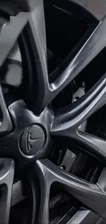 Closeup of a sleek black alloy wheel design.