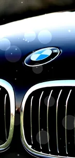 Close-up of a sleek black BMW grille and logo.