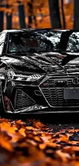 Sleek black car parked among autumn leaves.