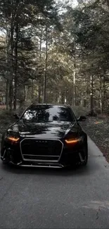 A sleek black car on a scenic forest road, exuding luxury and elegance.