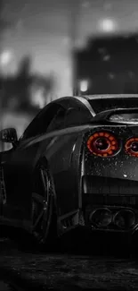 Sleek black car with red taillights in rainy urban scene.