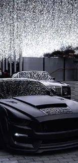 Sleek black car under sparkling lights at night.