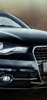 Luxurious black car against a blurred background.