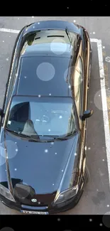 Aerial view of a sleek black car parked.