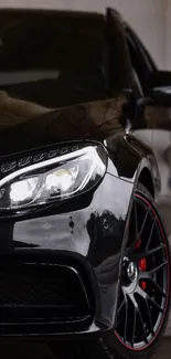 Sleek black car with illuminated headlights.