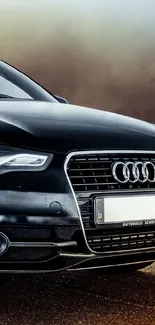 Sleek black car parked on a scenic road with a blurred background.