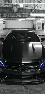 Sleek black luxury car parked in an urban garage.