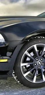 Black car wheel close-up with sleek design.