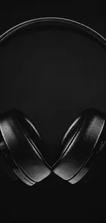 Sleek black headphones on dark background.