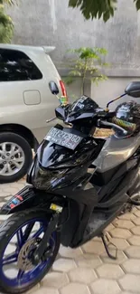 Sleek black motorcycle in urban parking area.