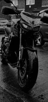 Black motorcycle on wet urban street, moody aesthetics.