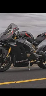 Sleek black motorcycle on open road with dynamic sky backdrop.