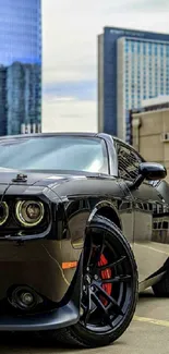 A sleek black muscle car parked in a city with skyscrapers in the background.