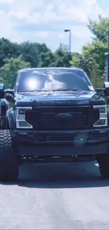 Sleek black pickup truck on open road.