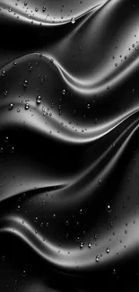 Sleek black satin surface with water droplets.