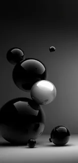 Sleek black spheres wallpaper for mobile phone, featuring glossy orbs.