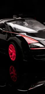 Sleek black sports car with red accents and glossy finish wallpaper.