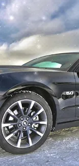 Sleek black sports car on snowy ground.